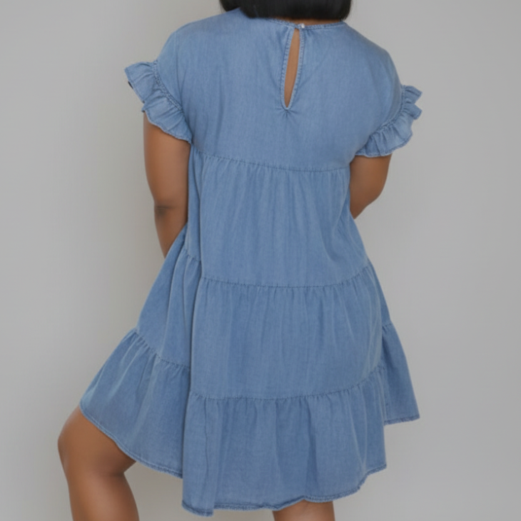 Light blue tiered babydoll denim dress with flutter ruffle cap sleeves and three-layer gathered skirt above the knee | The Pretty Pistol