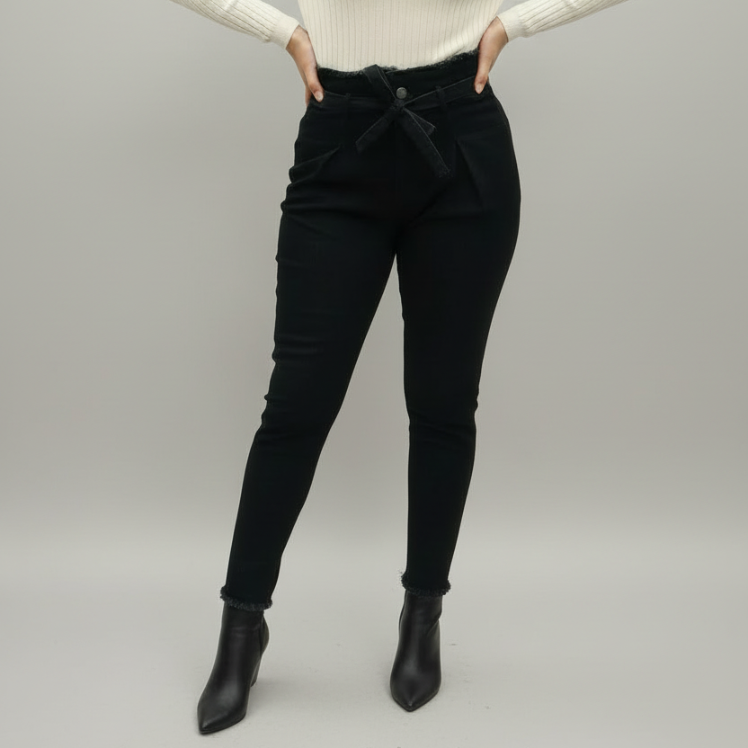 High waist paper bag black denim jeans with self-tie satin bow belt, frayed waist edge, and tapered slim leg with rolled frayed cuffs | The Pretty Pistol