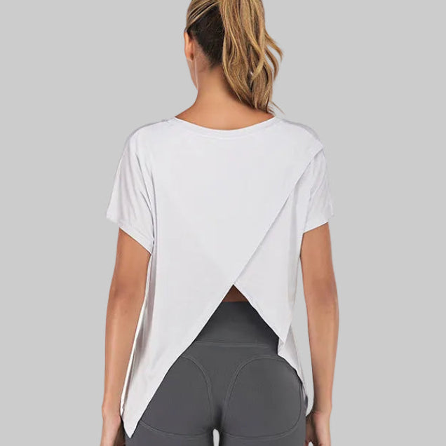 White yoga open back sports tee with split back hem and short sleeves, styled with gray leggings | The Pretty Pistol