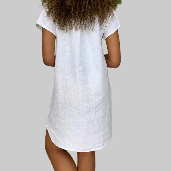 Navy V-neck cotton linen mini shift dress with short sleeves and side slits, styled with layered tassel necklace | The Pretty Pistol