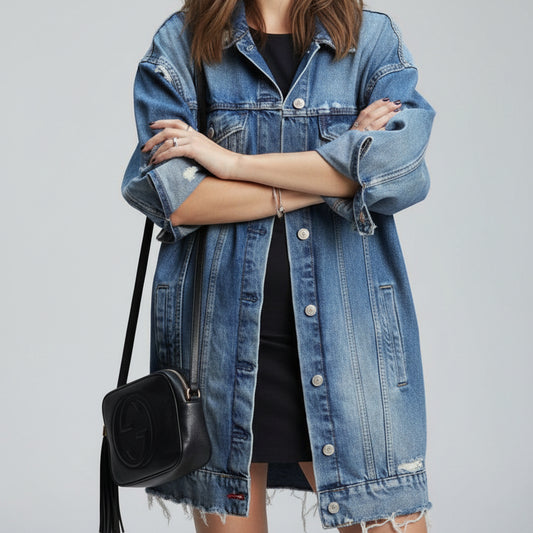 Women's oversized midi-length dark blue denim jacket worn street style with a black crossbody bag | The Pretty Pistol