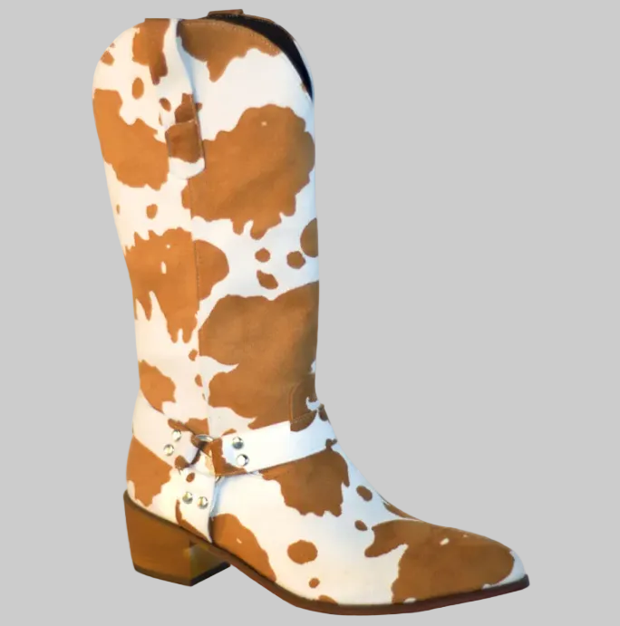 Brown and white cow print faux leather western boots with notched mid-calf shaft, harness strap with silver hardware, pointed toe, and stacked block heel | The Pretty Pistol