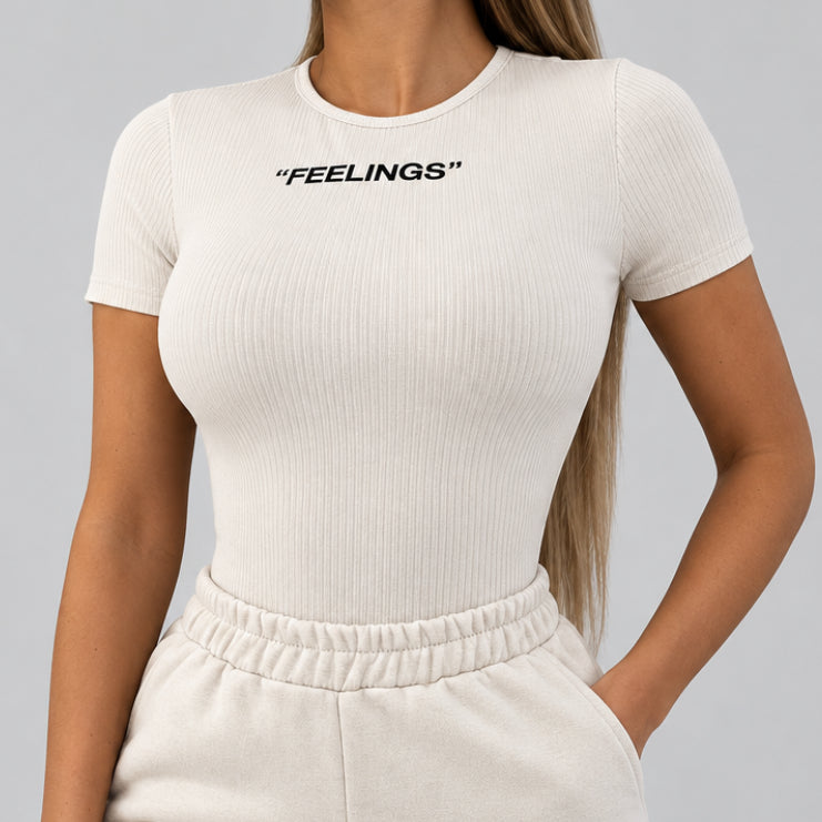 Women’s Feelings White Ribbed Short-Sleeve Bodysuit in White – FEELINGS Lettering, Round Neck, Sizes S–L | The Pretty Pistol