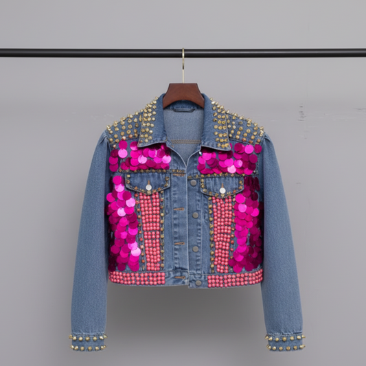 Cropped light blue denim jacket covered in gold and silver metal spike studs, oversized hot pink disc sequins, and pink rhinestone crystal detail | The Pretty Pistol