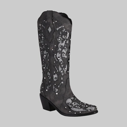 Black knee-high western cowboy boots with intricate silver embroidery, rhinestone crystal studs, and cutout overlay detailing, chunky block heel and pointed toe | The Pretty Pistol