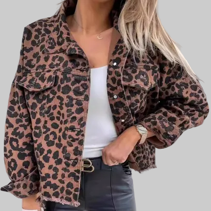 Women's oversized leopard print denim jacket with raw frayed hem, snap button-front closure, and two chest flap pockets, styled over a white tank and black leather pants | The Pretty Pistol